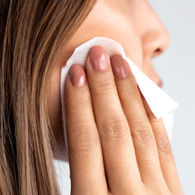 m-61 pad being swiped across cheek demonstrating one-minute application