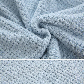 M-bestl towel draped over hand showing length and coverage advantage