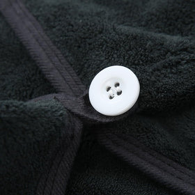 M-bestl towel next to hand to show 25x65 cm size and fit for most head sizes