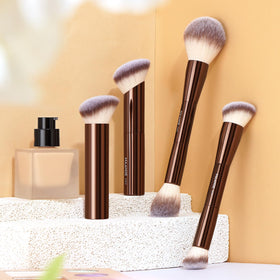 MAANGE brushes arranged with powders and creams displaying multiuse versatility