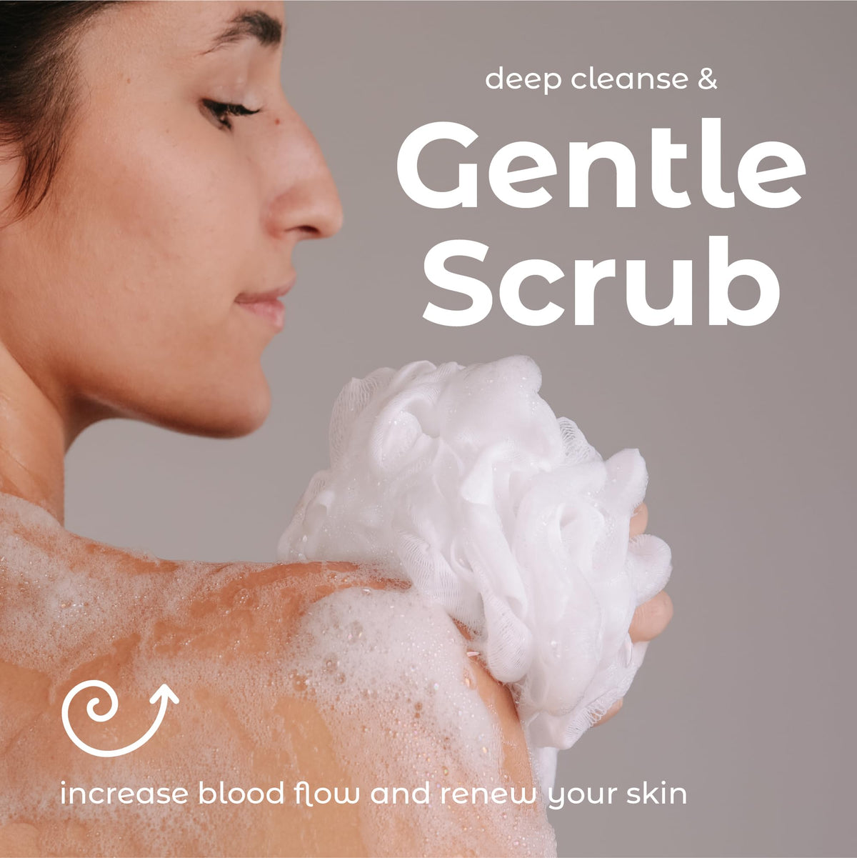 MainBasics loofah next to hand showing scale and compact, easy-to-grip size