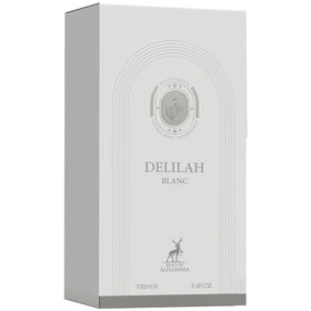 Maison Alhambra Delilah Blanc on vanity with flowers illustrating wearable citrus-floral elegance