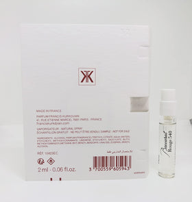 Maison Francis Kurkdjian 2ml vial held in hand for scale, demonstrates travel-sized convenience and potency
