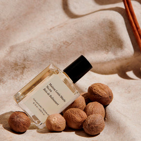 Maison Louis Marie bottle held in hand for scale illustrating travel-friendly benefit