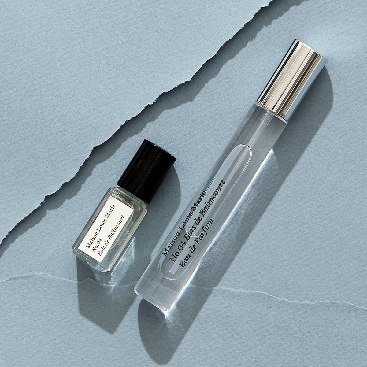 Maison Louis Marie bottle held in hand to show mini set size for portability
