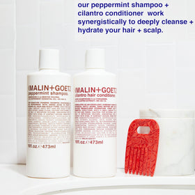 Malin + Goetz bottle on bathroom shelf creating a simple, modern routine vibe