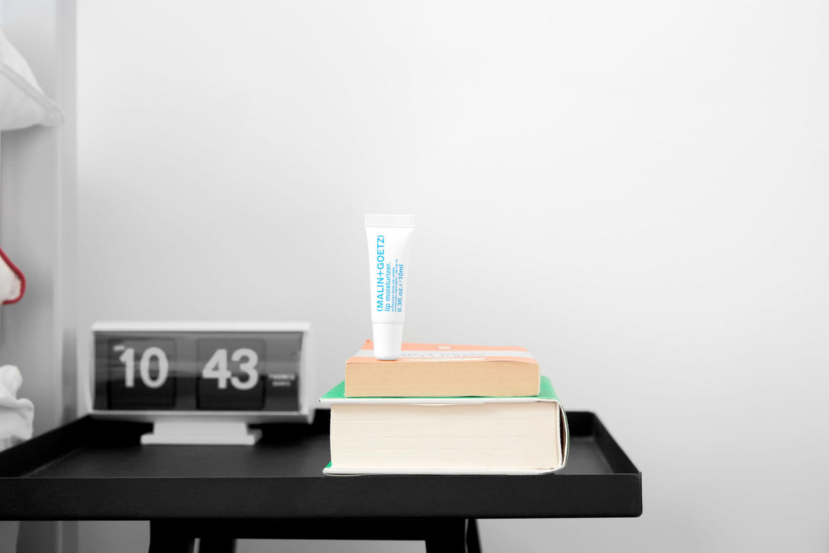 MALIN+GOETZ tube in hand showing travel size convenience and portability