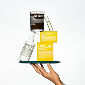 MALIN+GOETZ bottle on bathroom counter conveying minimalist, modern lifestyle appeal