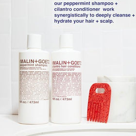 MALIN+GOETZ shampoo styled in bathroom setting conveying daily refresh ritual