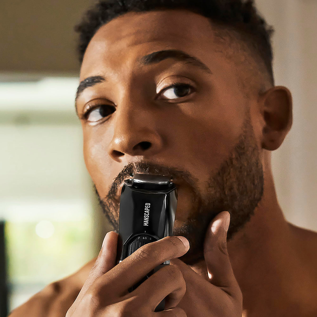 MANSCAPED blade lifting guard detail showing hair-lift action for smoother single strokes