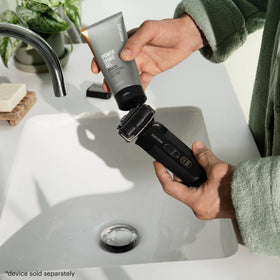 MANSCAPED bottle next to common items to show true 6 fl oz size for informed purchase