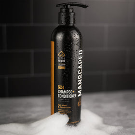 MANSCAPED aluminum bottle on recycled materials signifying eco-conscious packaging