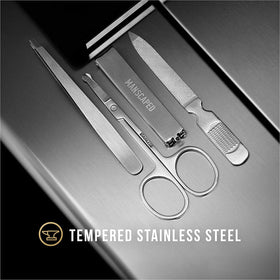 MANSCAPED arranged four tools laid out to show clippers scissors tweezers and file for clarity