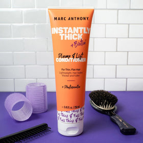 Marc Anthony conditioner being applied in shower for easier detangling