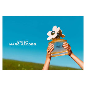 Marc Jacobs Daisy 1.6 fl oz beside everyday items showing compact travel size