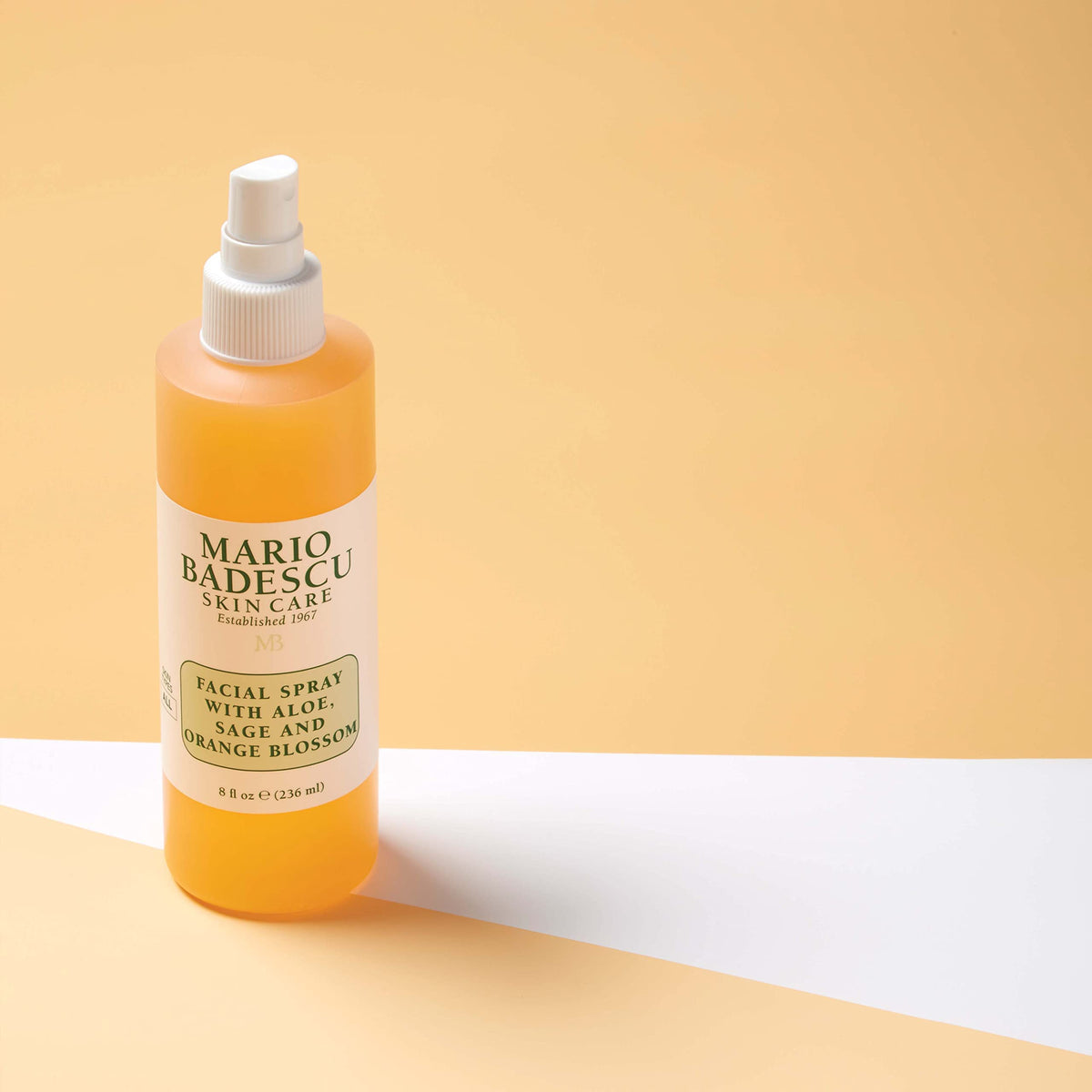 Mario Badescu bottle held in hand to show 8 fl oz scale and portability