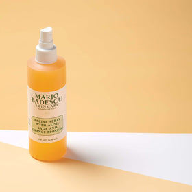 Mario Badescu bottle held in hand to show 8 fl oz scale and portability