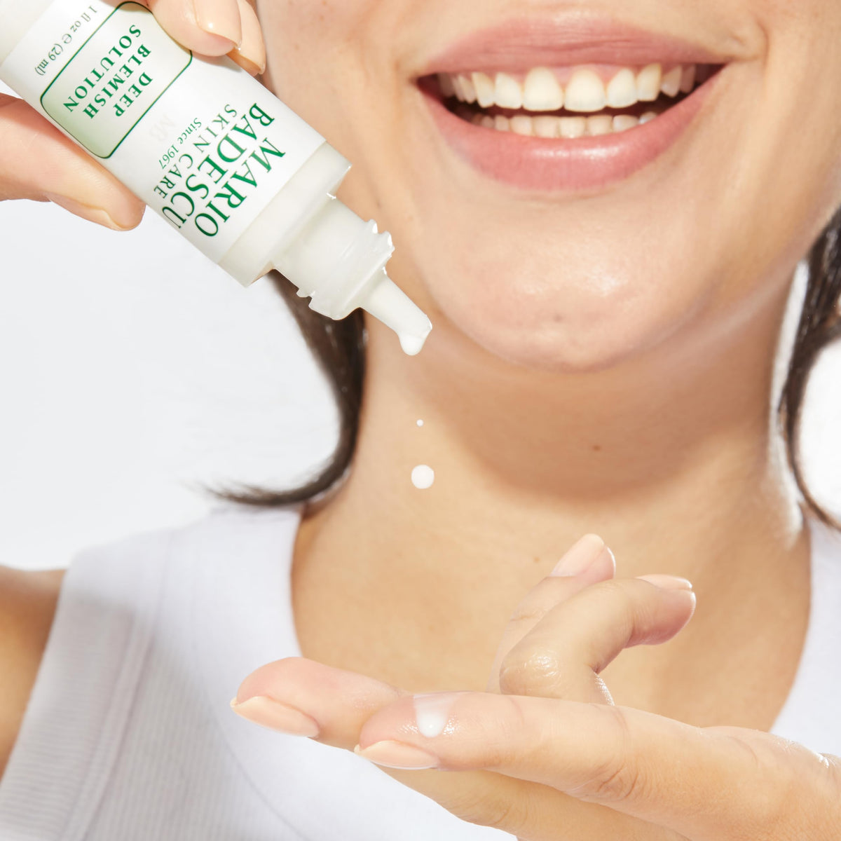 Mario Badescu dropper applying spot treatment to fingertip for precise targeting
