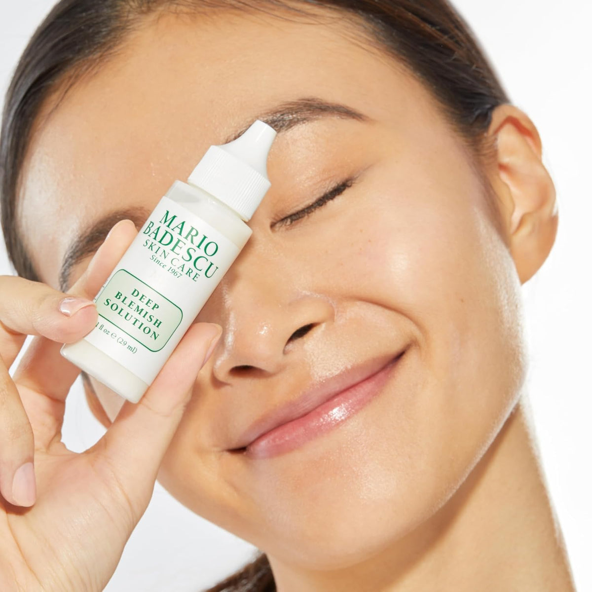 Mario Badescu bottle beside cleanser in bathroom scene showing morning and night use