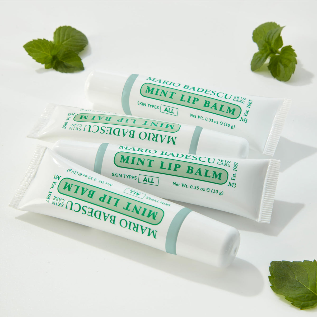 Mario Badescu lip application in hand demonstrating smooth coverage