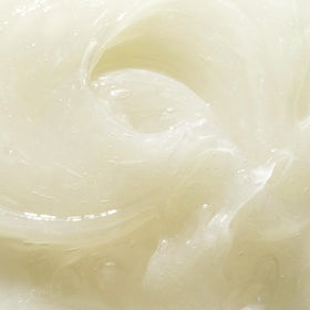 Mario Badescu product next to coconut and mango indicating tropical scent