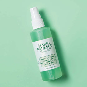 Mario Badescu bottle next to travel items showing compact size and portability