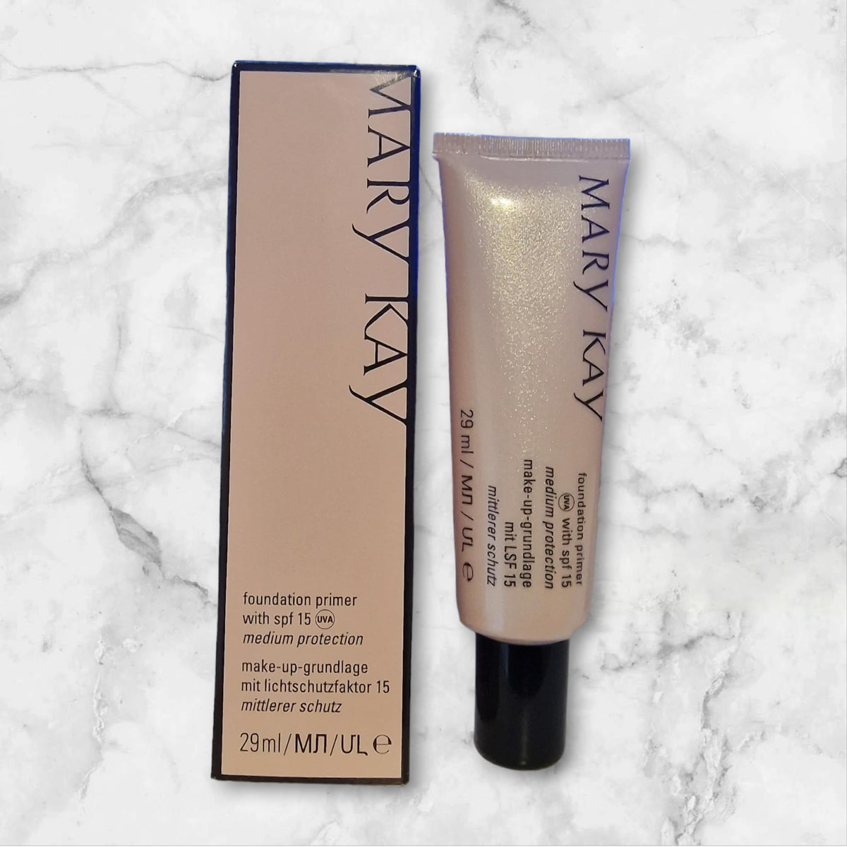 Mary Kay primer texture applied on hand close-up demonstrating lightweight spreadability