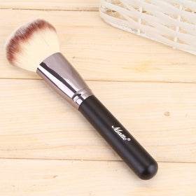 Matto brush beside coin to show size and balanced length for control