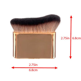 Maui Babe bottle next to brush to show size and easy coverage benefits