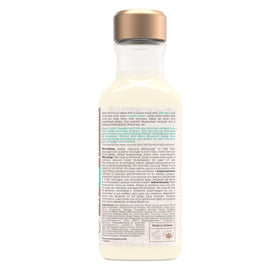 Maui Moisture bottle on bathroom shelf with curls styled and hydrated