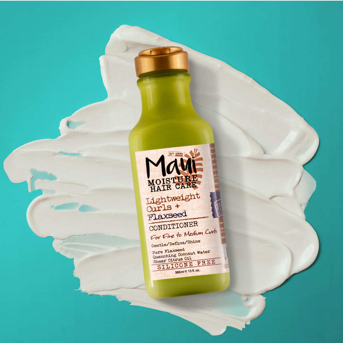 Maui Moisture bottle beside flaxseed and coconut illustrating natural oils