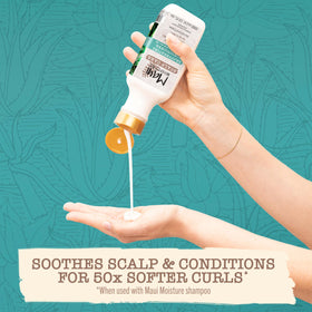 Creamy conditioner squeezed from bottle showing texture that detangles and softens curls