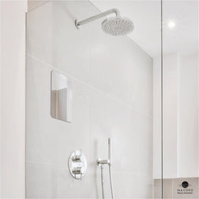 Hand holding Mavoro 7x9 mirror to show scale and lightweight easy-placement benefit
