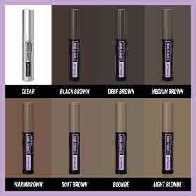 Maybelline brow gel on vanity next to makeup showing quick touch-up benefit