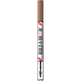 Maybelline Build-A-Brow placed with travel items highlighting easy touch-ups and all-day hold