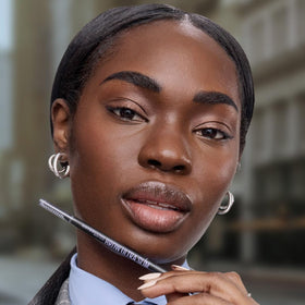 Maybelline on a vanity with mirror showing polished brows and everyday use