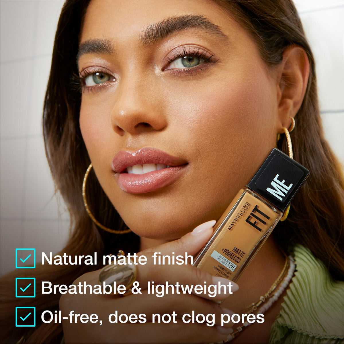MAYBELLINE bottle staged with makeup kit showing easy layering benefit