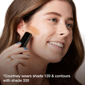 MAYBELLINE stick resting with makeup bag to show portability and everyday use