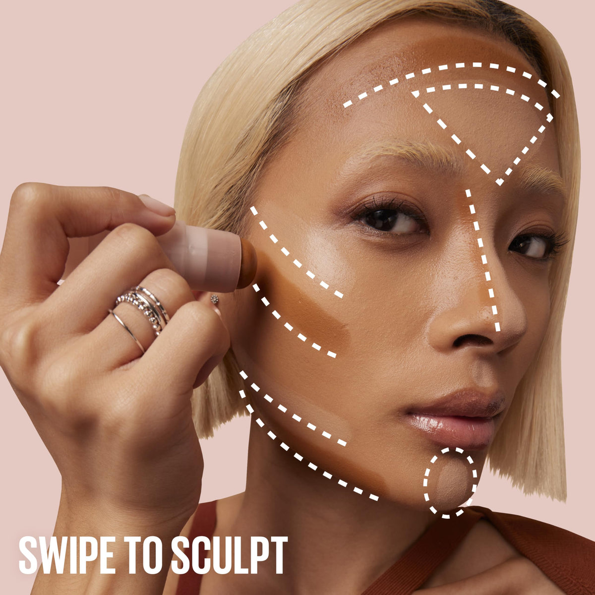 MAYBELLINE model applying Lifter Stix on cheek demonstrating sculpting benefit