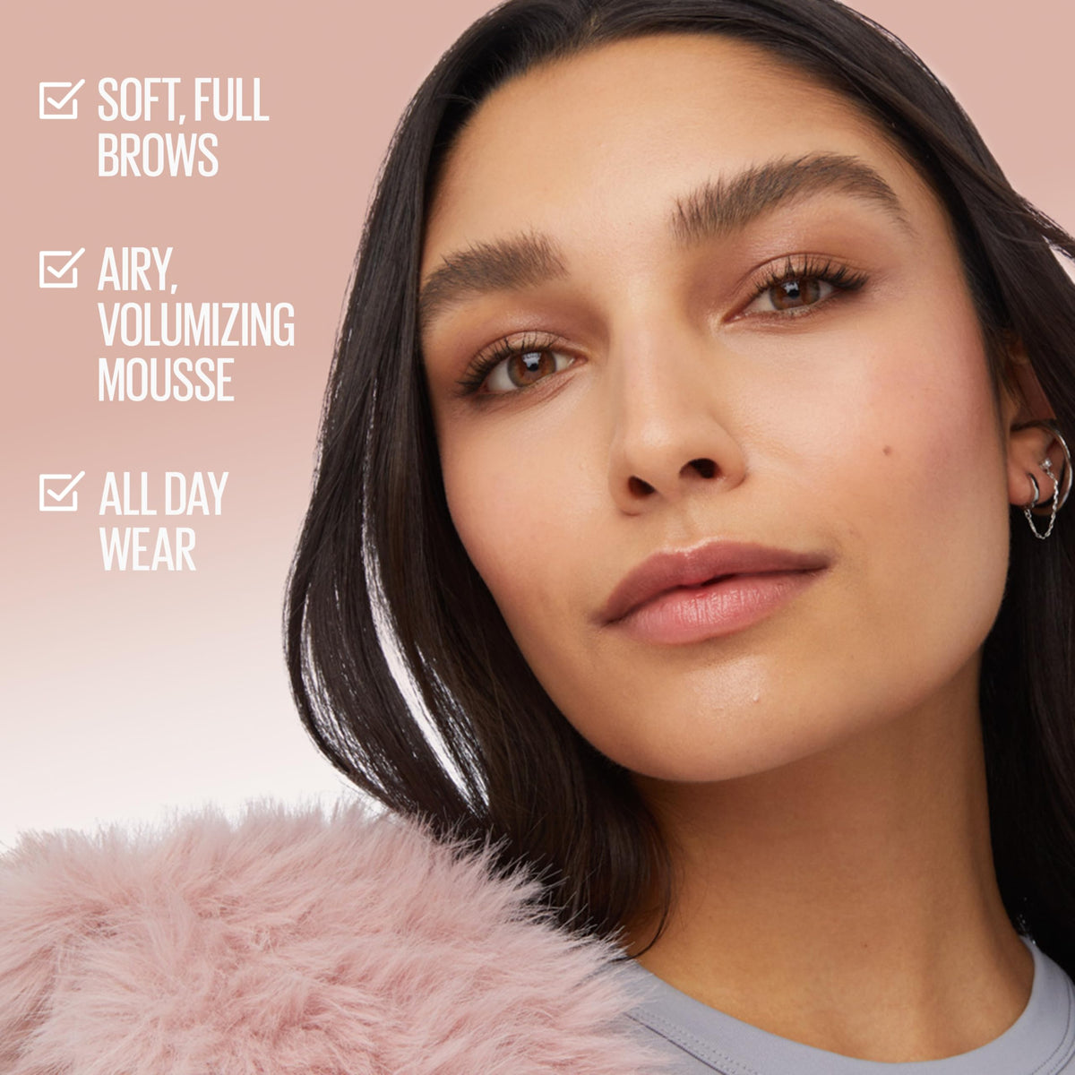 Maybelline Superfluff mousse texture on fingertip demonstrating lightweight, buildable coverage