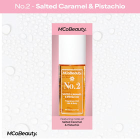 Model spritzing MCoBeauty No.2 through hair to show lasting scent on strands
