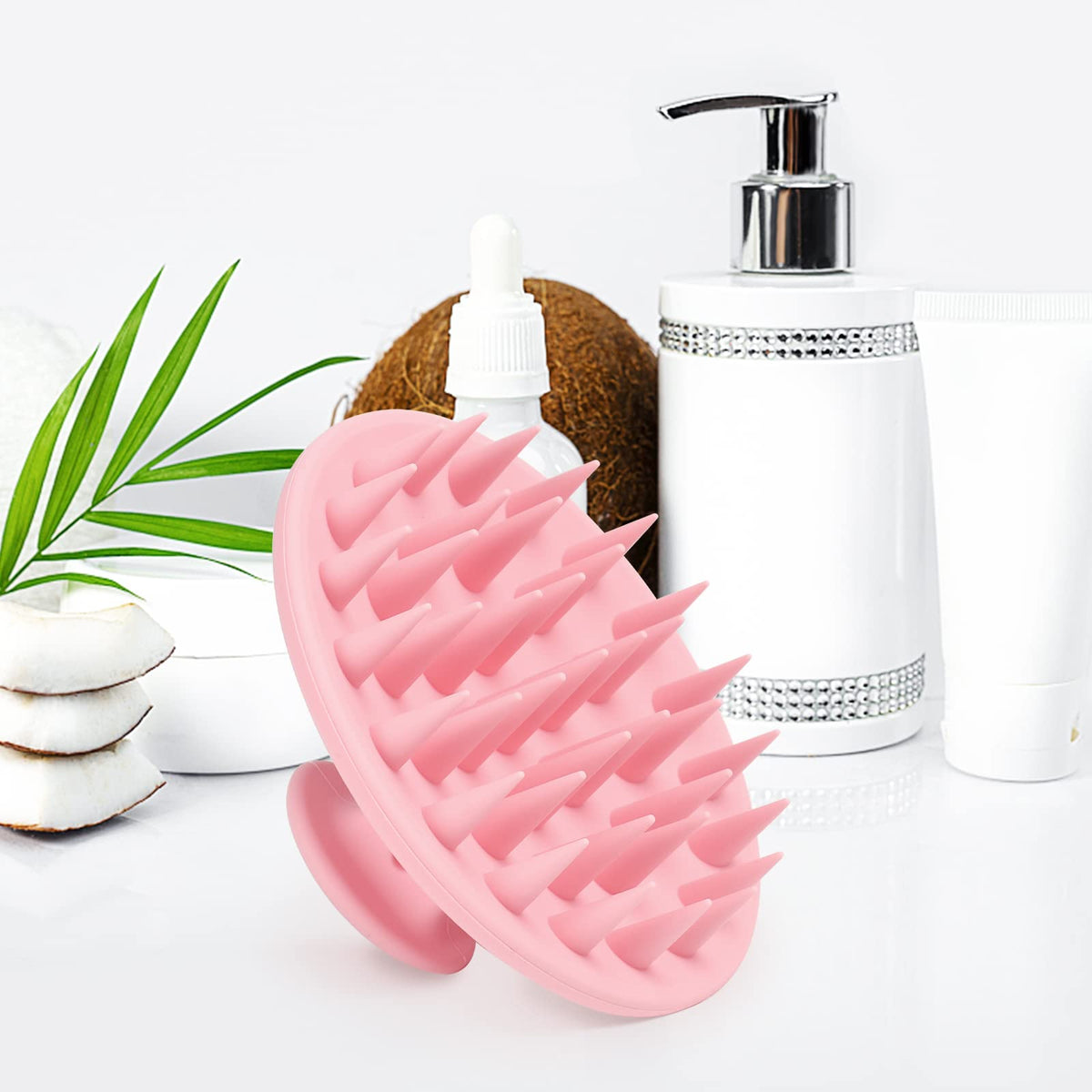 Meartchy held in hand to show size and larger scalp coverage benefit