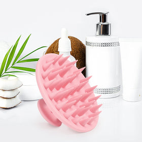 Meartchy held in hand to show size and larger scalp coverage benefit