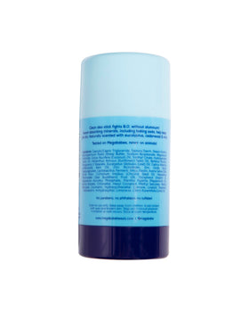 Megababe deodorant on a beach towel showing hot-weather protection benefits