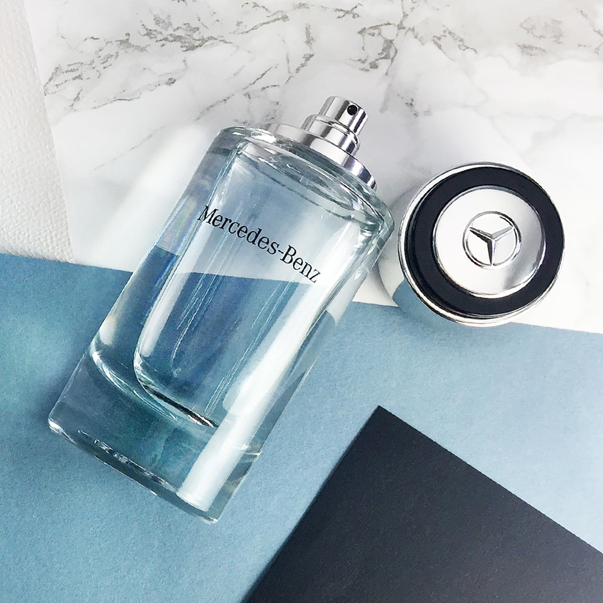 Mercedes Benz 4 oz bottle next to common items showing size and portability