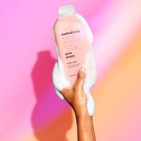 Method 18 oz bottle next to hand to show size and scale
