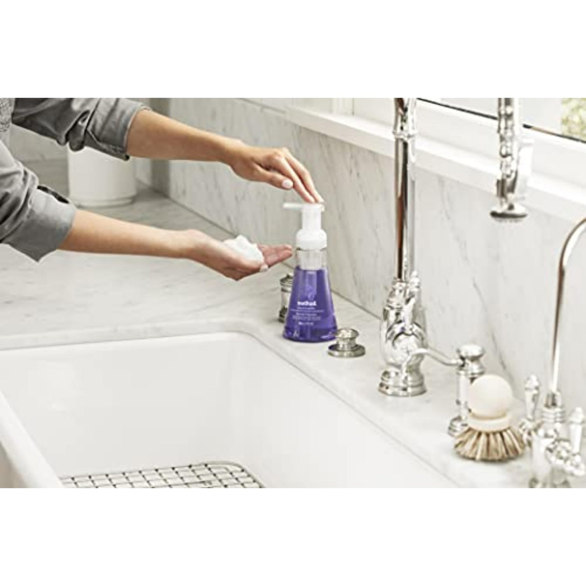 Method bottle held in hand showing 10 fl oz scale and convenient size
