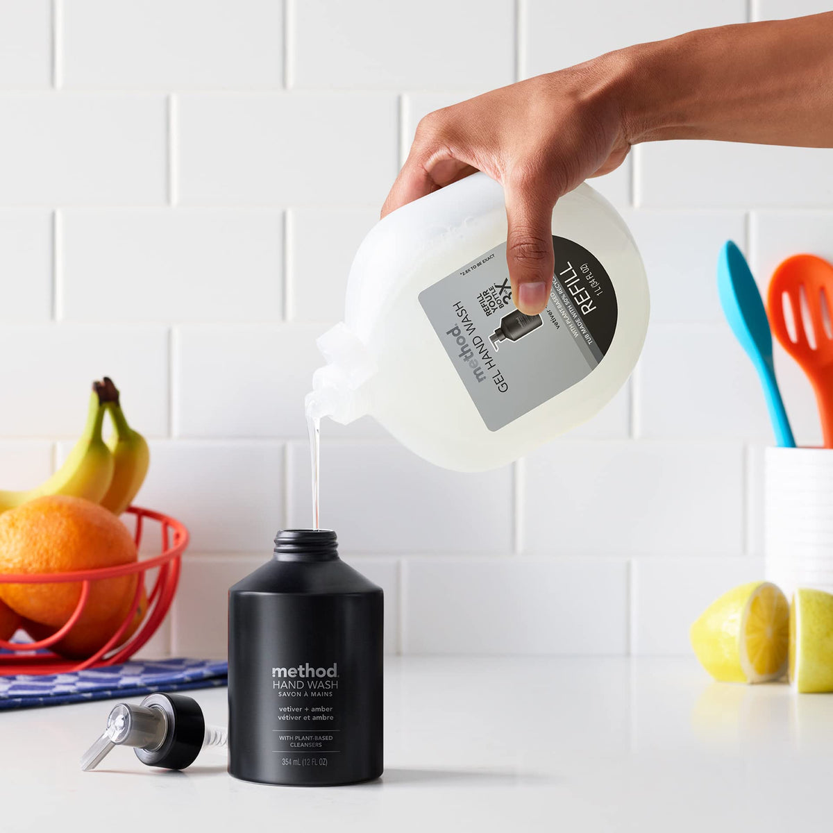 Method bottle held in hand for scale showing 12 oz size and refillable convenience benefit