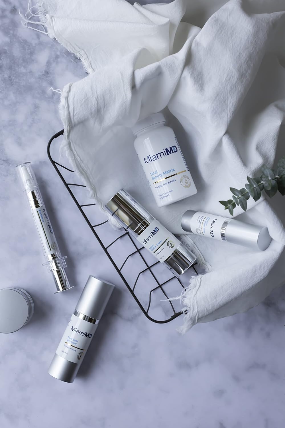 MiamiMD bottle on bathroom vanity suggesting daily skincare routine