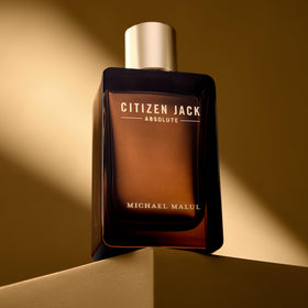Michael Malul bottle held in hand illustrating 3.4 oz scale and travel convenience